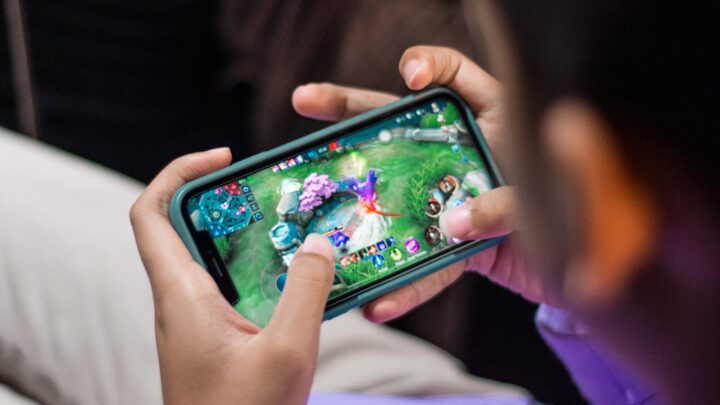 Mobile gaming on a smartphone representing Mobile Legends Bang Bang 10th Anniversary skins and rewards
