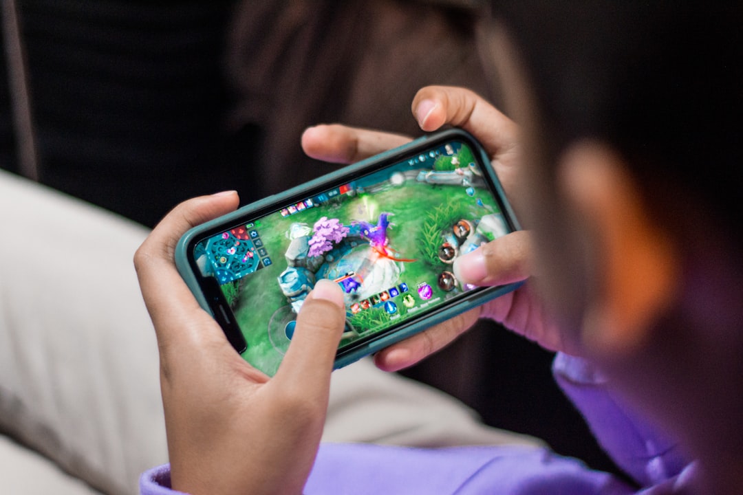 Mobile gaming on a smartphone representing Mobile Legends Bang Bang 10th Anniversary skins and rewards