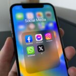 Smartphone displaying social media apps for Meta One subscription coverage