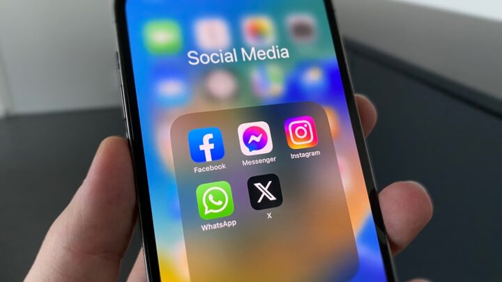 Smartphone displaying social media apps for Meta One subscription coverage