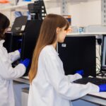 Researchers working with computers illustrating AI-assisted research