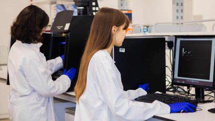 Researchers working with computers illustrating AI-assisted research