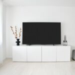 Modern Australian-style living room with a large television and media console, illustrating a smart home setup