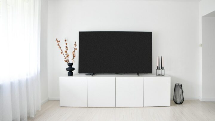 Modern Australian-style living room with a large television and media console, illustrating a smart home setup