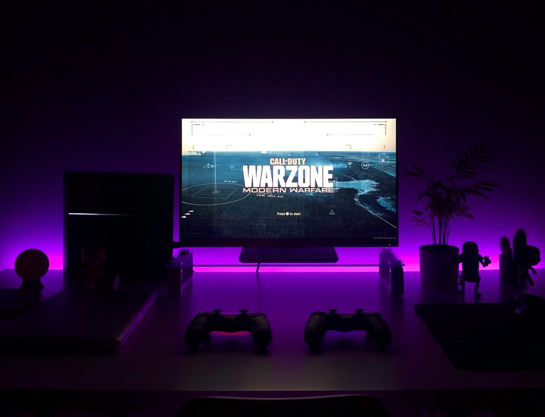 Gaming desk and monitor illustrating ways to play PlayStation games on a PC; photograph by Fábio Magalhães via Unsplash