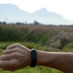 Person checking a fitness tracker, illustrating the reported Google Fitbit Edge wearable