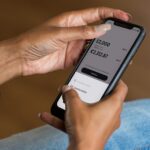 Person using a mobile banking app as Australian borrowers respond to higher interest rates