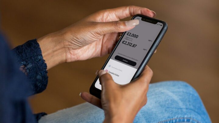 Person using a mobile banking app as Australian borrowers respond to higher interest rates