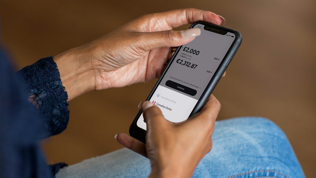 Person using a mobile banking app as Australian borrowers respond to higher interest rates