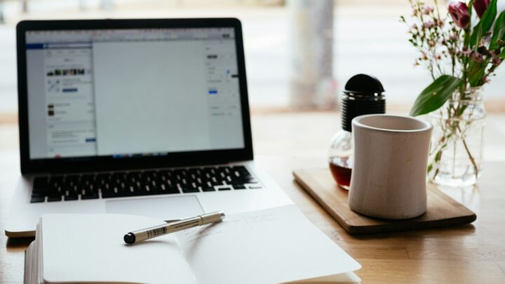 Laptop and notebook on a desk, illustrating new open-source office software alternatives to Microsoft Word, Excel and PowerPoint