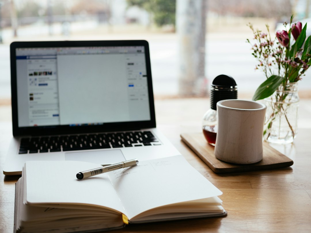 Laptop and notebook on a desk, illustrating new open-source office software alternatives to Microsoft Word, Excel and PowerPoint