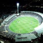 Australian stadium at night illustrating AI sports prediction for Roosters vs Knights