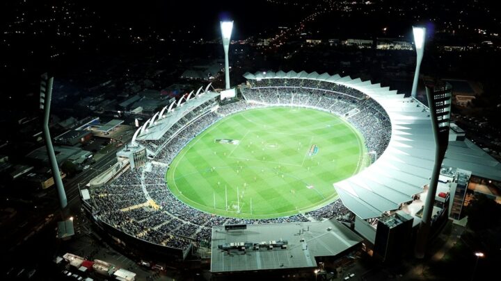 Australian stadium at night illustrating AI sports prediction for Roosters vs Knights
