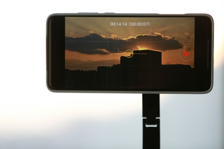 Smartphone filming a sunset scene, illustrating mobile phone filmmaking versus traditional cinema cameras
